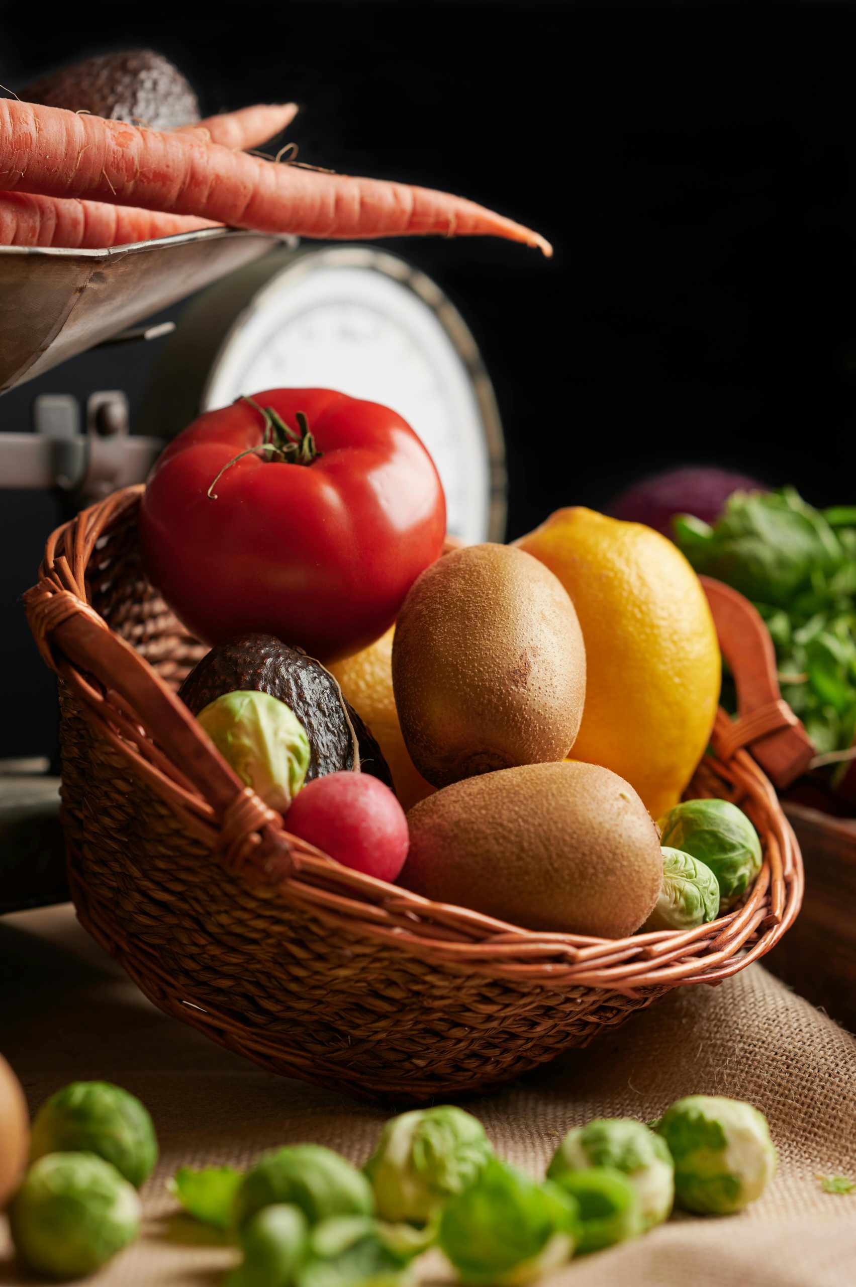 A woven basket filled with fresh fruits and vegetables, perfect for a healthy lifestyle.